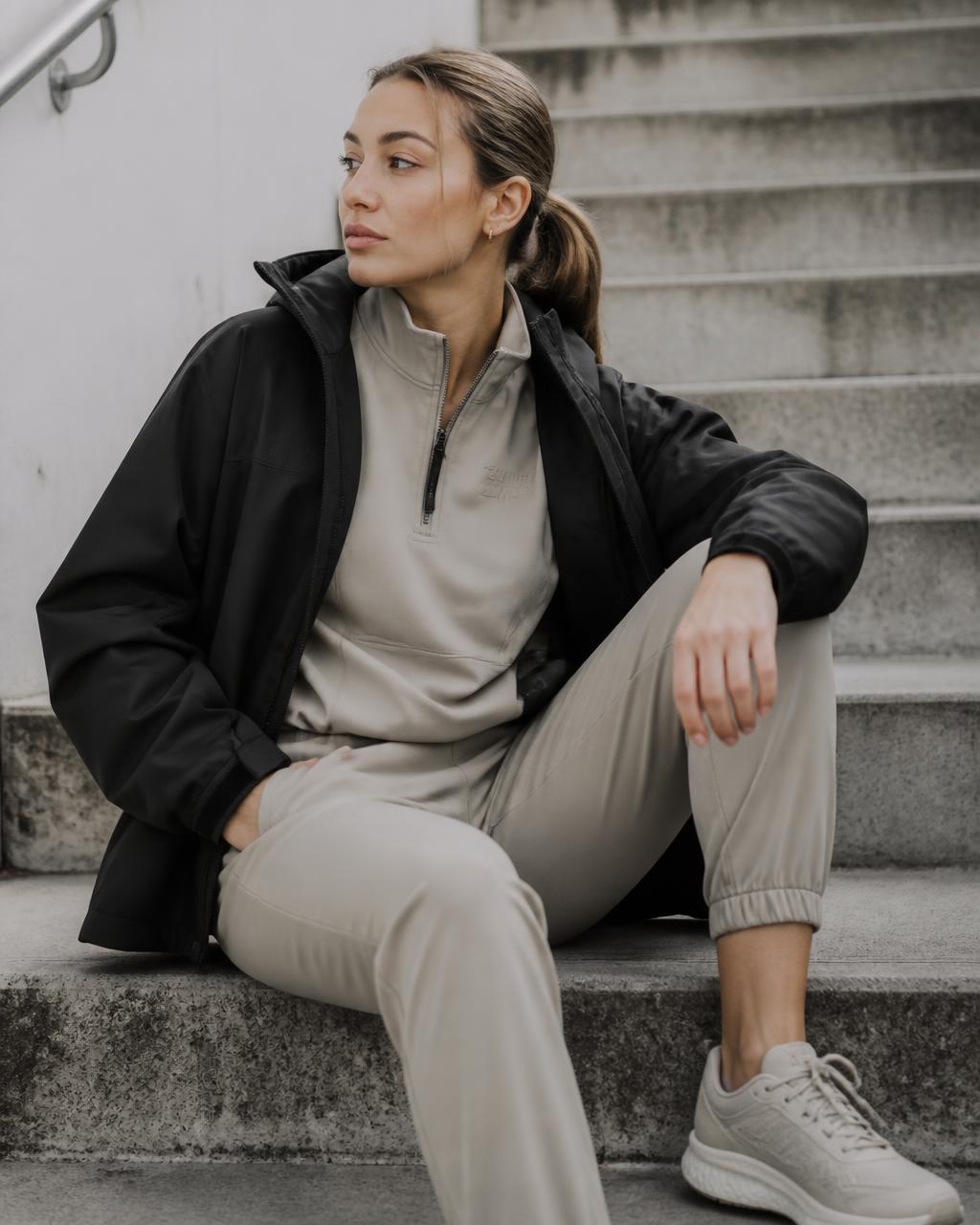 Model in SHIFT apparel against a concrete wall